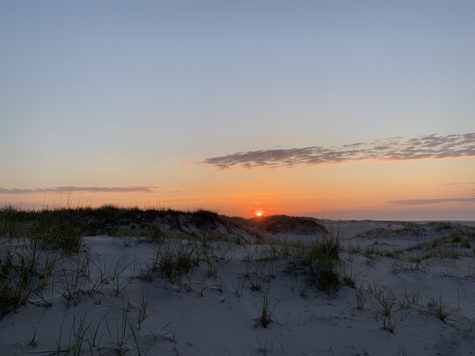 Ephesians 1 NASB.  Morning sun rising over the sand dunes on a quiet beach.