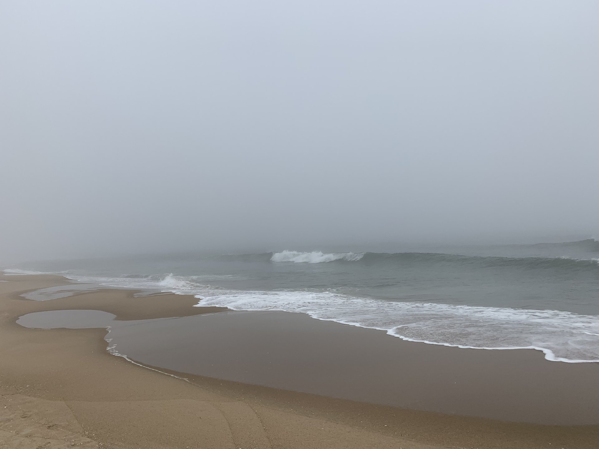 2 Corinthians 5 NASB.  Marine layer of fog on the ocean beach limiting visability.